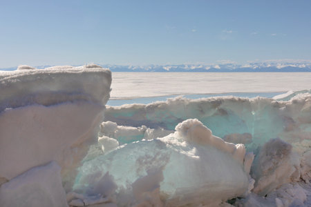 Frozen Lake and Snowy Mountains Winter Landscapeの写真素材