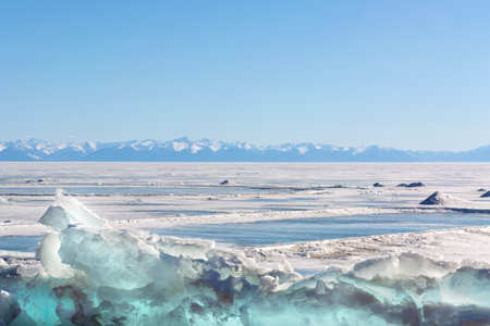 Frozen Lake and Snowy Mountains Winter Landscapeの写真素材