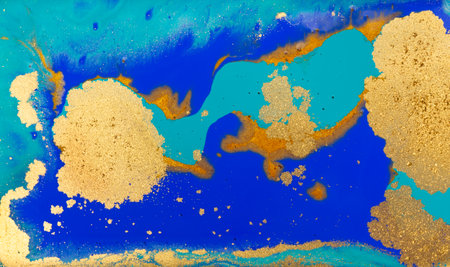 Golden Dust on Liquid Blue Ink Wave Background.
