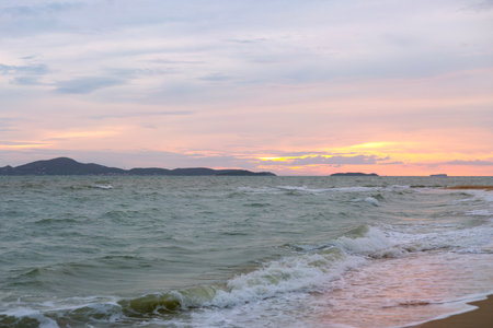 Raging Sea with Sunset Sky Backgroundの写真素材