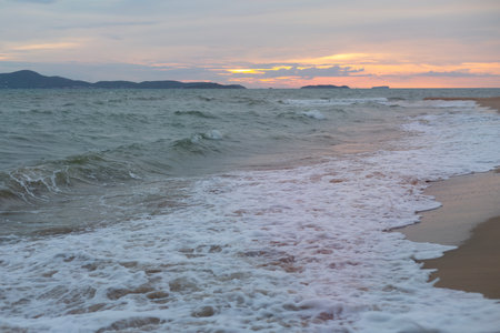 Raging Sea with Sunset Sky Backgroundの写真素材