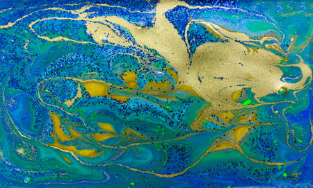 Blue and Gold Glitter on Liquid Blue Ink Background.の写真素材