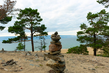 Zen Pyramid Stones and Larches on the Baikal Sand Beachの写真素材