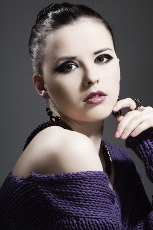 beautiful girl with perfect skin with jewelry on a dark backgroundの写真素材