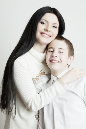 Portrait of beautiful smiling family  mother and son on a white backgroundの写真素材