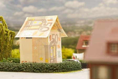 a euro bill house in a green neighbourhood sceneryの写真素材