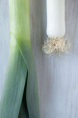 Leeks on white wooden backgroundの写真素材