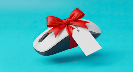 Give the gift of tech delight your friends and family with this computer mouse wrapped in a red ribbonの素材