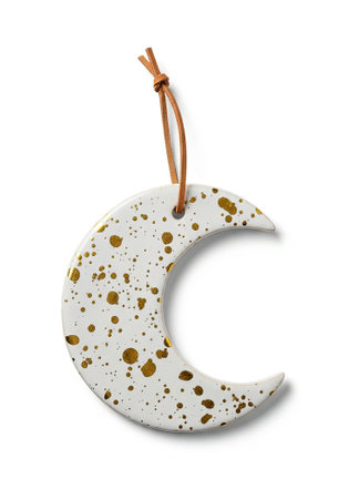 Modern white ceramic moon ornament with gold splatter pattern hanging on leather cordの素材