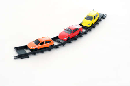 three colorful toy cars on railway