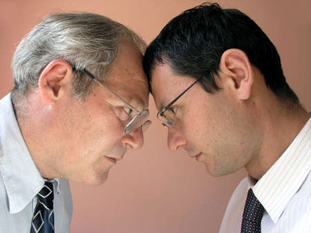 Two businessman from different generations. Conflict of powers.      