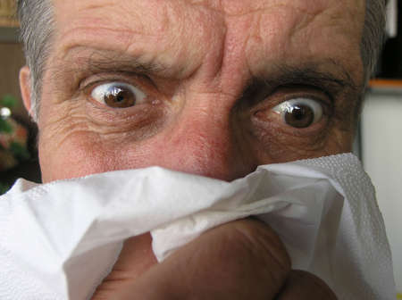 Men blowing his nose.... influenza ...       の写真素材