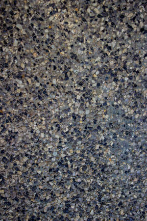 A small stone on cement lined with crowded.