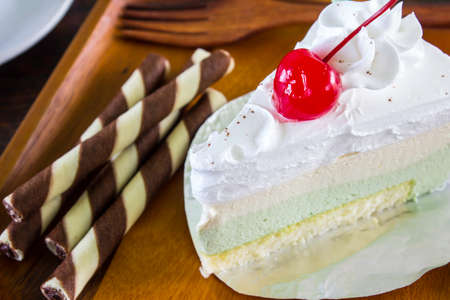 A delicious cake with a coffee and the pocketbook.