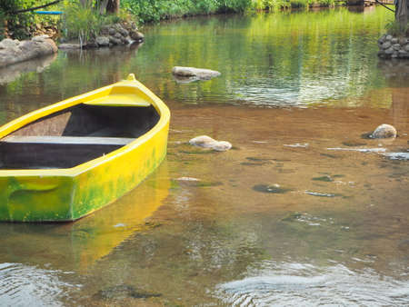 A yellow Canoe in the lake, clear water see through the sandの写真素材