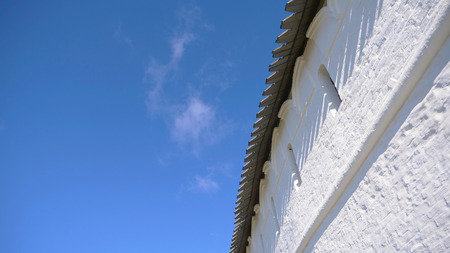 White retro vintage stone wall of Historic and Architectural Complex of the Kazan Kremlin with blue...