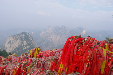 Red blessing cloth on the Sacred Taoist mountain Mount Huashan, popular touristic place in Chinaのeditorial素材