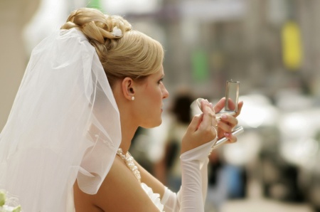 Bride applying makeup on her faceの写真素材