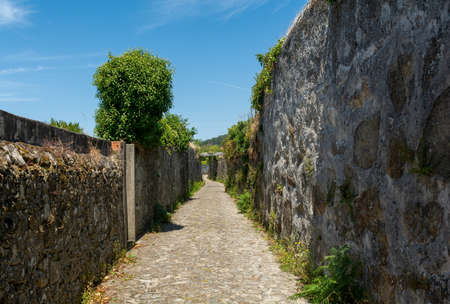 The ancient Roman road with stone walls both sides in Portugalの写真素材