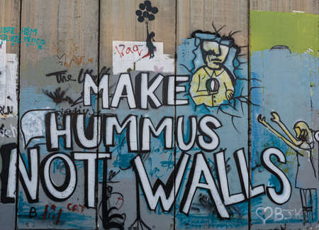 Make hummus not walls on the wall in Bethlehem, Palestine made by Bansky.のeditorial素材