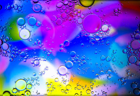 Abstract colorful Background Oil in Water surface Foam of Soap with Bubbles macro shot close-up. Abstract background. Multicolored stains water stains.Image of oil drop on water for modernの写真素材