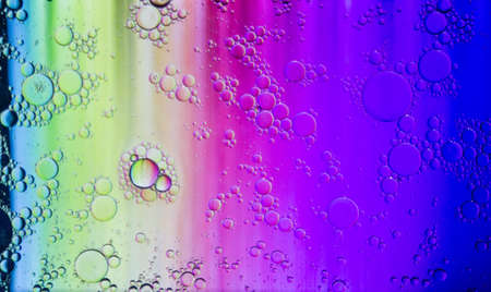 Abstract colorful Background Oil in Water surface Foam of Soap with Bubbles macro shot close-up. Abstract background. Multicolored stains water stains.Image of oil drop on water for modernの写真素材