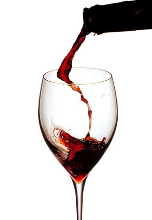 Splashing wine on white background        の写真素材