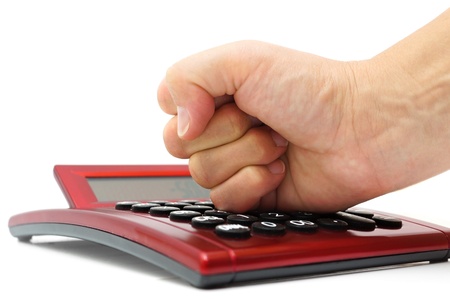 financial mistake concept with woman hand hitting calculatorの写真素材
