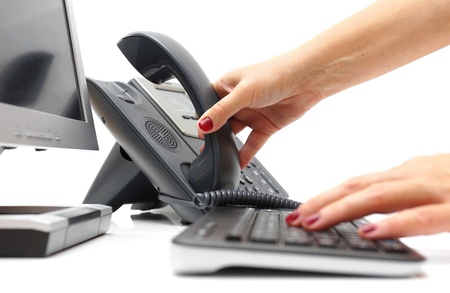 woman is picking up the phone in support centerの写真素材
