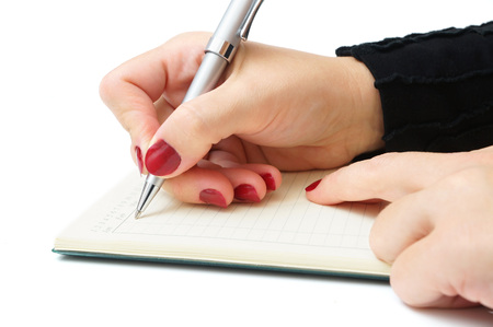 businesswoman writing in her notepadの写真素材