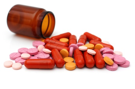 various of pills and capsules scattered on deskの写真素材