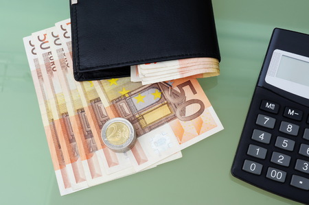 concept of making money with wallet,money,calculator on glass tableの写真素材