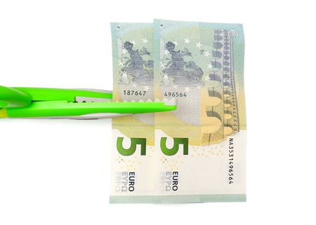 cutting costs concept with money, scissorsの写真素材