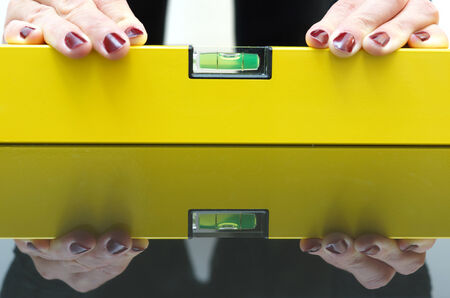 A woman using a spirit level for home work