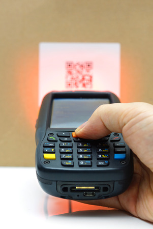 scanning QR code label on the carton with laserの写真素材
