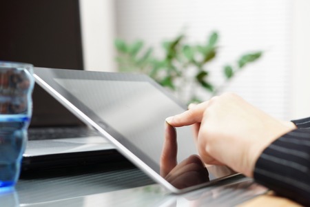 businesswoman using tablet in officeの写真素材