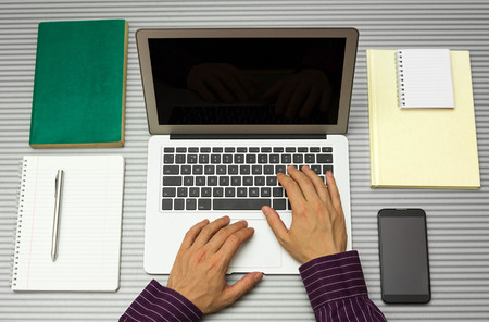 top view of man working with laptop in office or at home studyingの写真素材