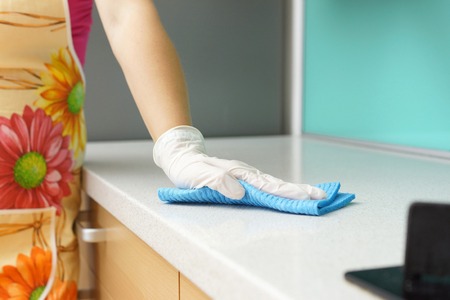 Woman Wearing Apron Cleaning Kitchen counter
