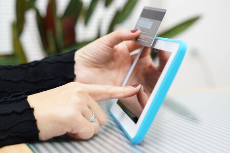 Woman holding tablet pc and credit card , Internet Shopping Conceptの写真素材