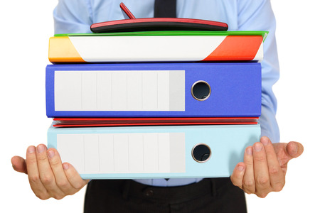 businessman carrying bindersの写真素材