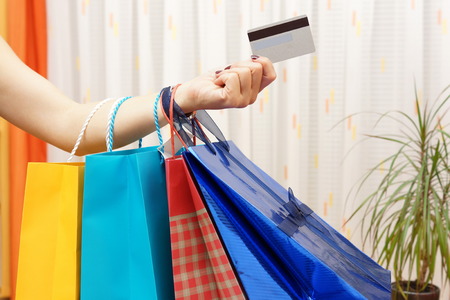 Woman with  shopping bags bought with a debit or credit card at home  Shopping from home conceptの写真素材