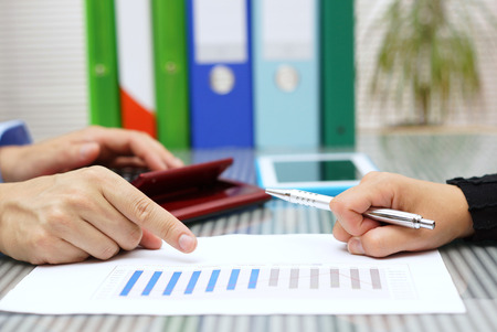 businessmen explaining report sales to clientの写真素材