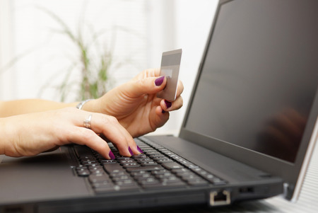 Businesswoman is using laptop for on line payment with credit cardの写真素材