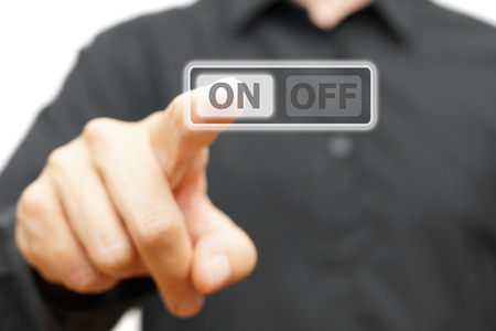 man hand pressing ON buttonの写真素材