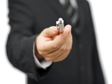 Closeup of businessman offering a penの写真素材