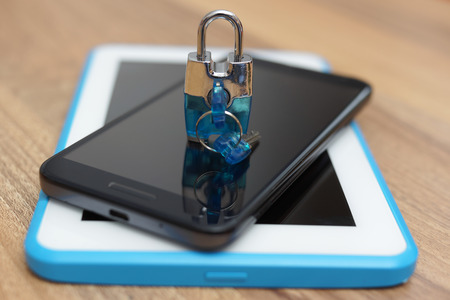 Padlock on smart phone and tablet computer. Safety & security on web devicesの写真素材