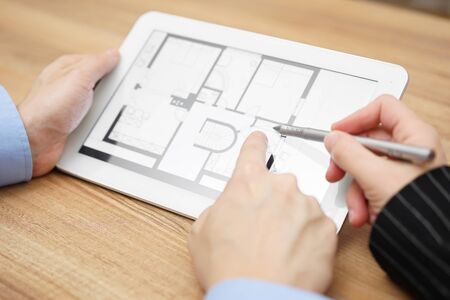 real estate agent showing home projection on tablet  computerの写真素材