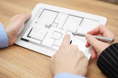 real estate agent showing home projection on tablet  computerの写真素材