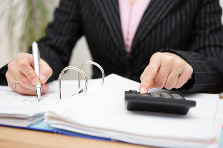 busy female accountant working with documentsの写真素材