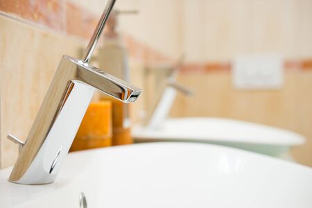 modern bathroom with sink and faucet, blurred backgroundの写真素材